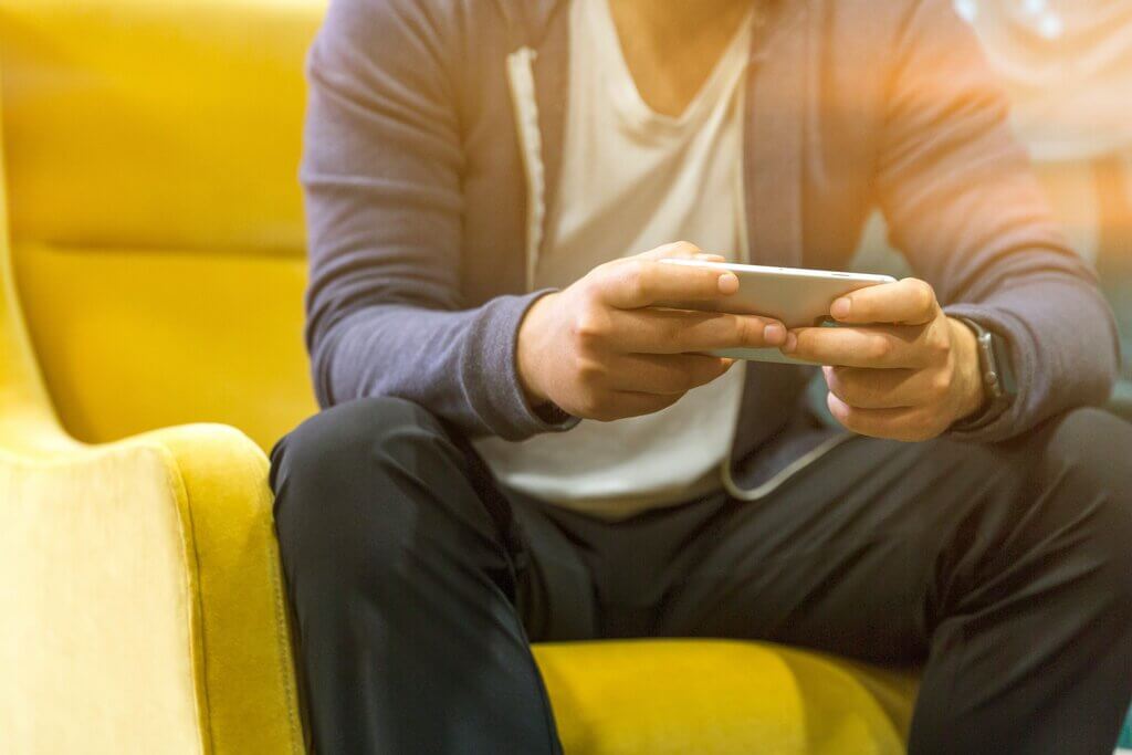 man-sitting-on-his-phone-ordering-erectile-dysfunction-treatment-from-webdoctor.ie