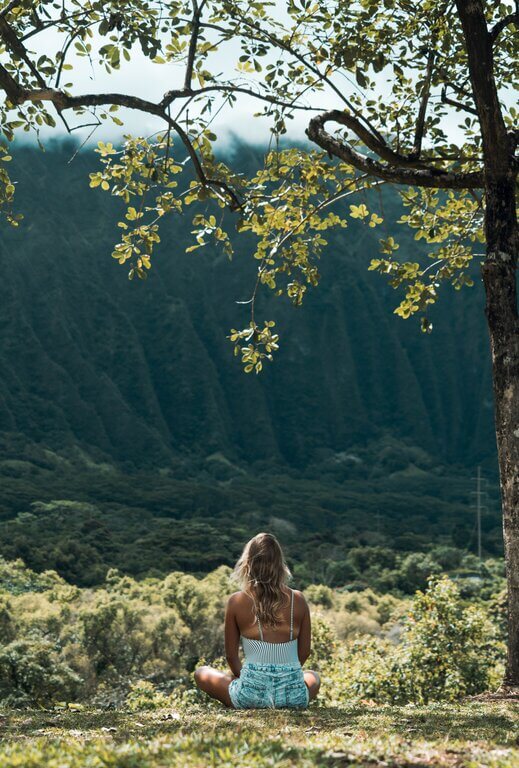 woman-sitting-down-at-a-park-on-holiday