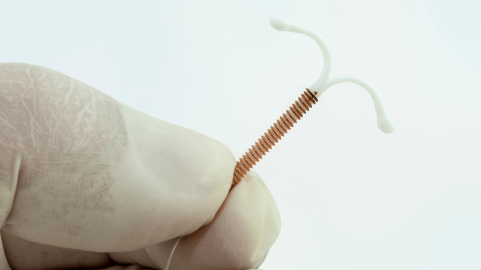 doctor-holding-IUD