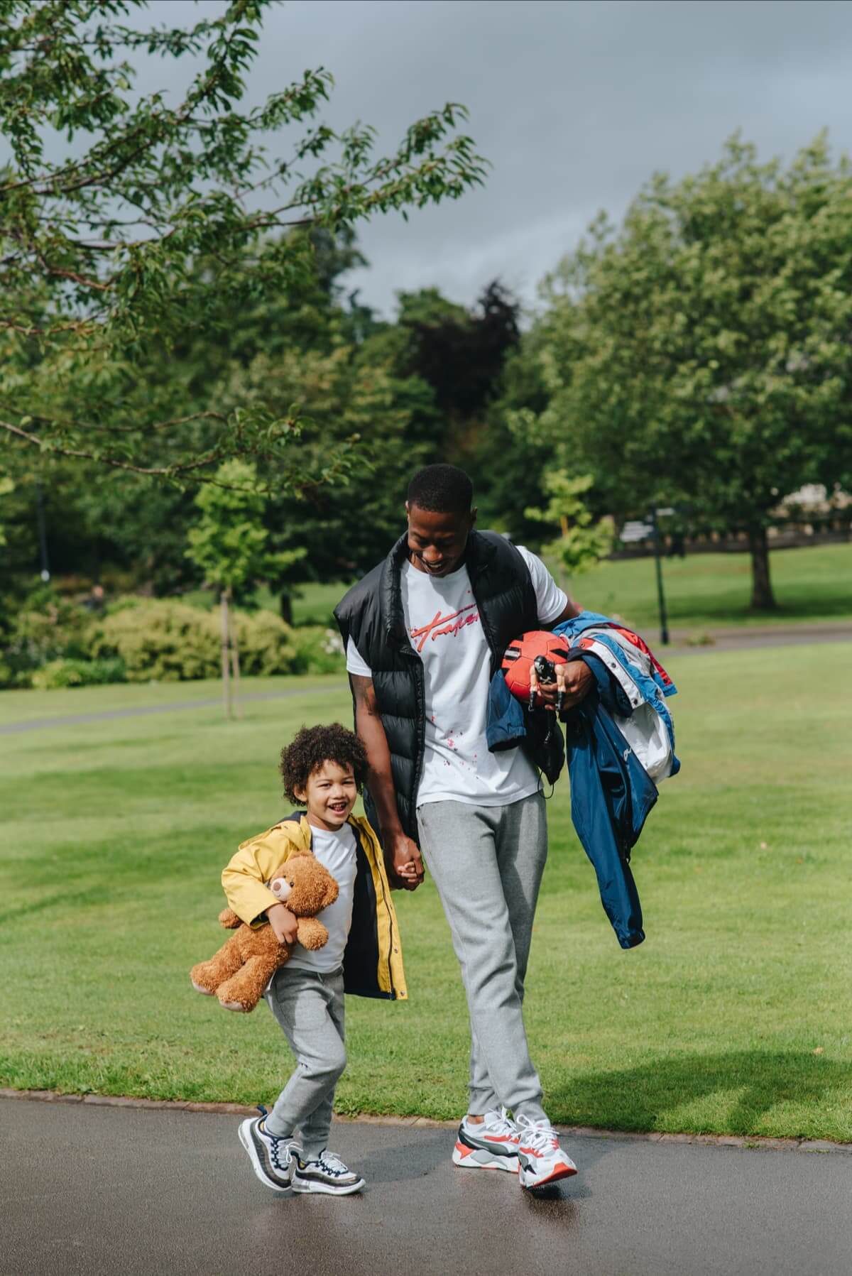 man-and-his-child-walking-in-the-park man-and-his-child-walking-in-the-park