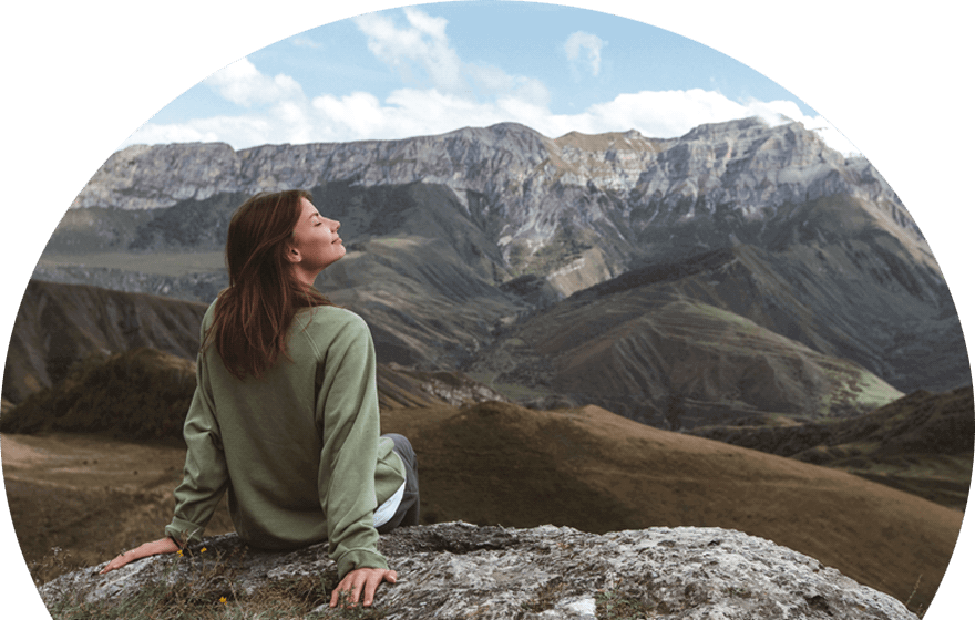 woman-sitting-down-in-the-mountains-breathing-in-the-fresh-air
