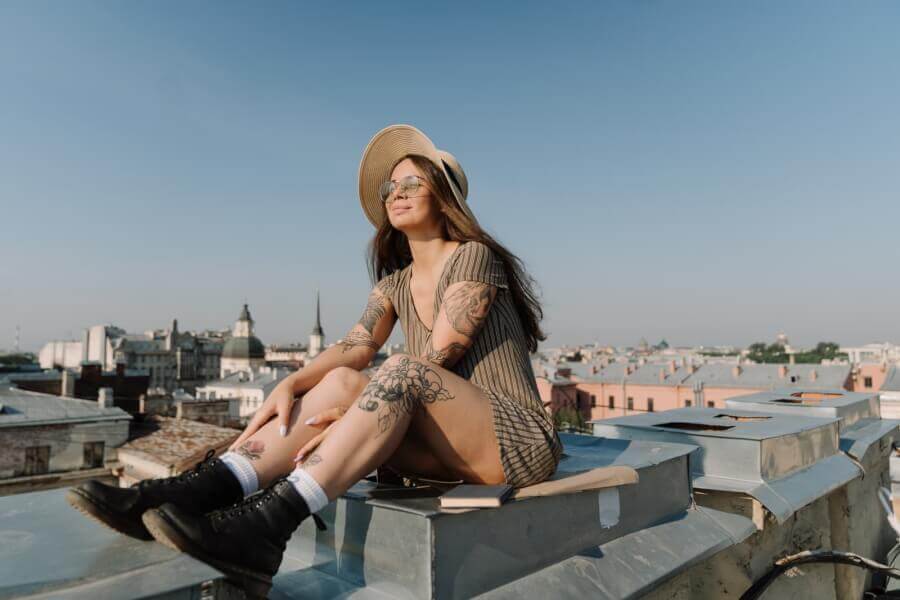 woman-sitting-on-a-wall-enjoying-the-sunshine