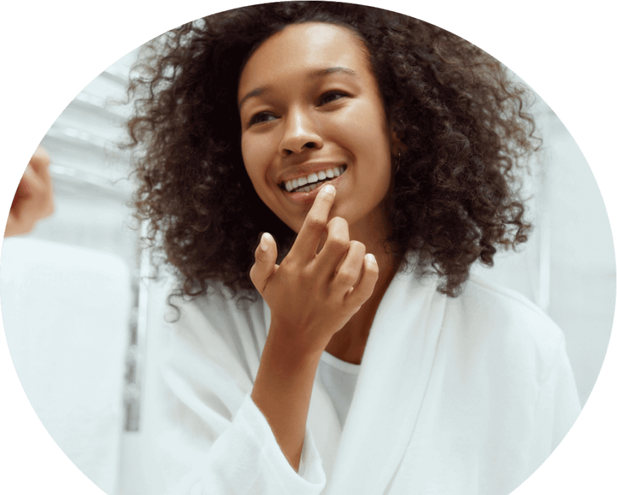 Woman-checking-cold-sore-in-the-mirror