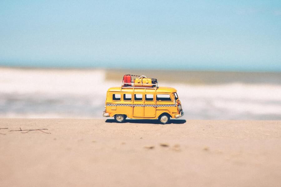 toy-camper-van-sitting-on-the-beach